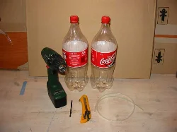 You will need two bottles (preferably 2-liter), a utility knife, a drill, and a 5.5mm drill bit.